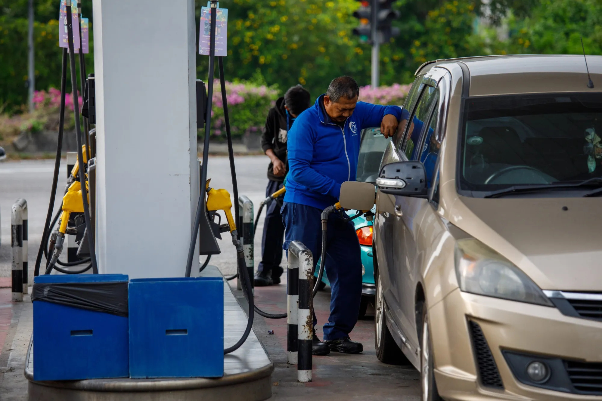 A customer refuels at a gas station near West Port Klang, Selangor, Malaysia.