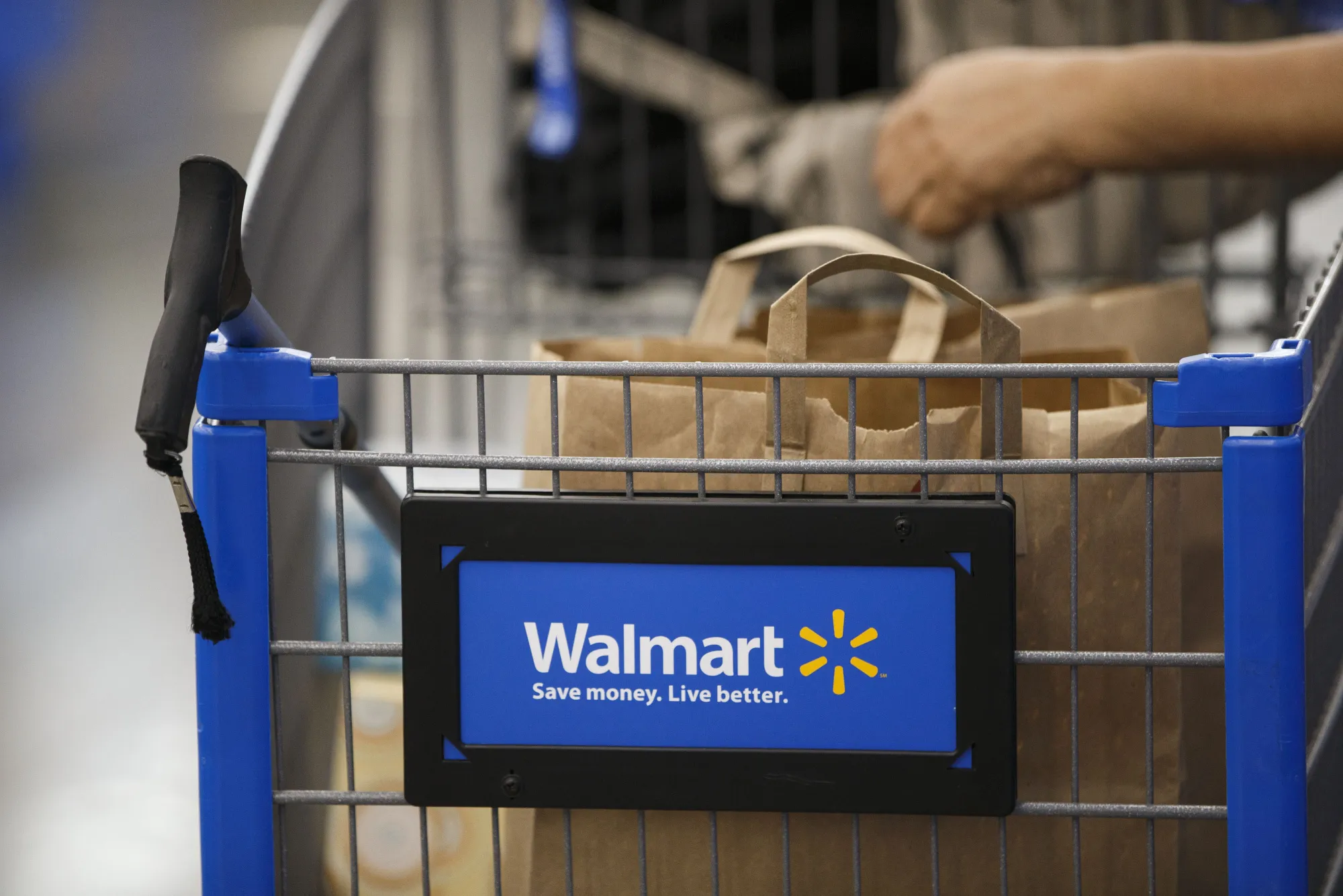 The Wal-Mart Stores Inc. logo is displayed on a shopping cart inside the company's location in Burbank, California, U.S., on Tuesday, Nov. 22, 2016.