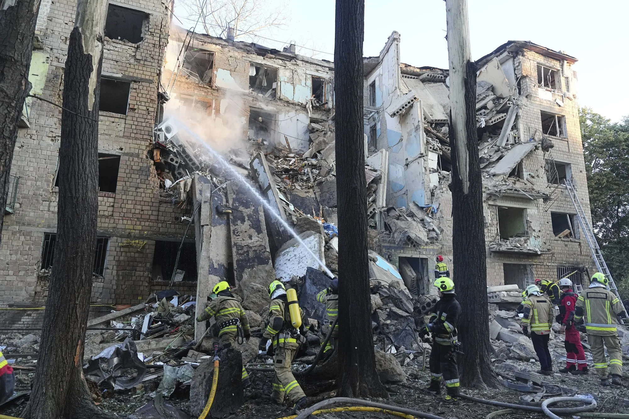 Firefighters tackle a blaze at an apartment building after a Russian attack, in Kyiv, on June 23.