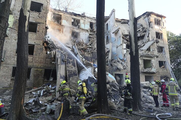 Firefighters tackle a blaze at an apartment building after a Russian attack, in Kyiv, on June 23.
