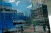 Buildings and pedestrians reflected on an electronic stock board outside a securities firm in the Shinjuku district of Tokyo, Japan, on Wednesday, Feb. 17, 2021. A surge in Japanese shares this week has pushed the Nikkei 225 past the 30,000 level for the first time since 1990.