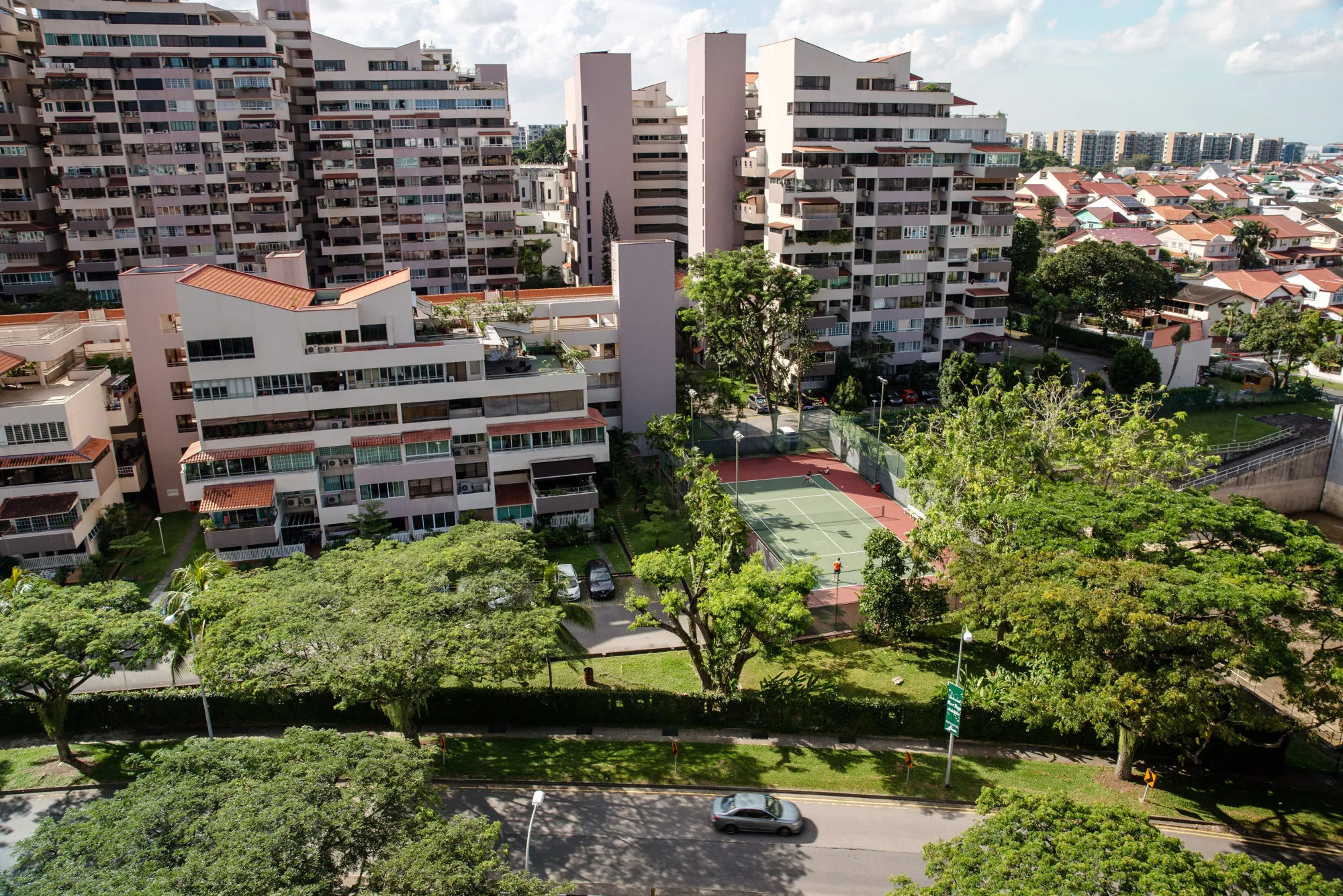 People play tennis in a court surrounded by residential buildings in the Bedok area of Singapore.&nbsp;