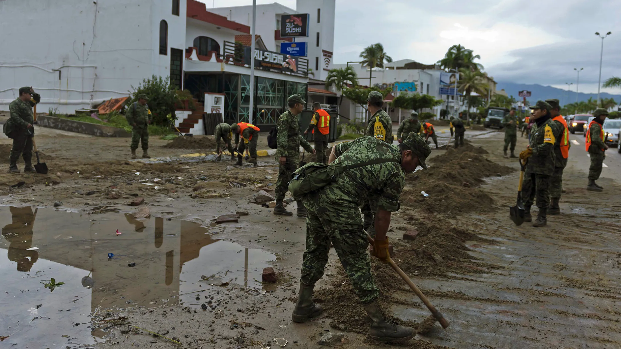 Soldiers remove sand from the street in Manzanillo, state of Colima, after Hurricane Patricia hit the shore, on Oct. 24.
