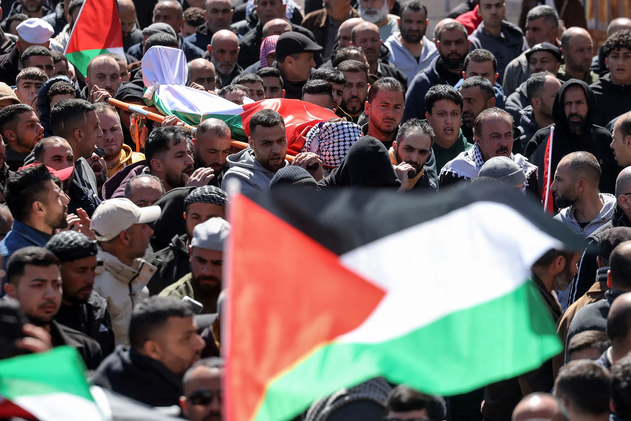 Mourners carry the bodies of three Palestinians killed in a reported attack by Israeli settlers in&nbsp;Abu Falah, northeast of Ramallah in the&nbsp;West Bank, during the funeral on March 8.