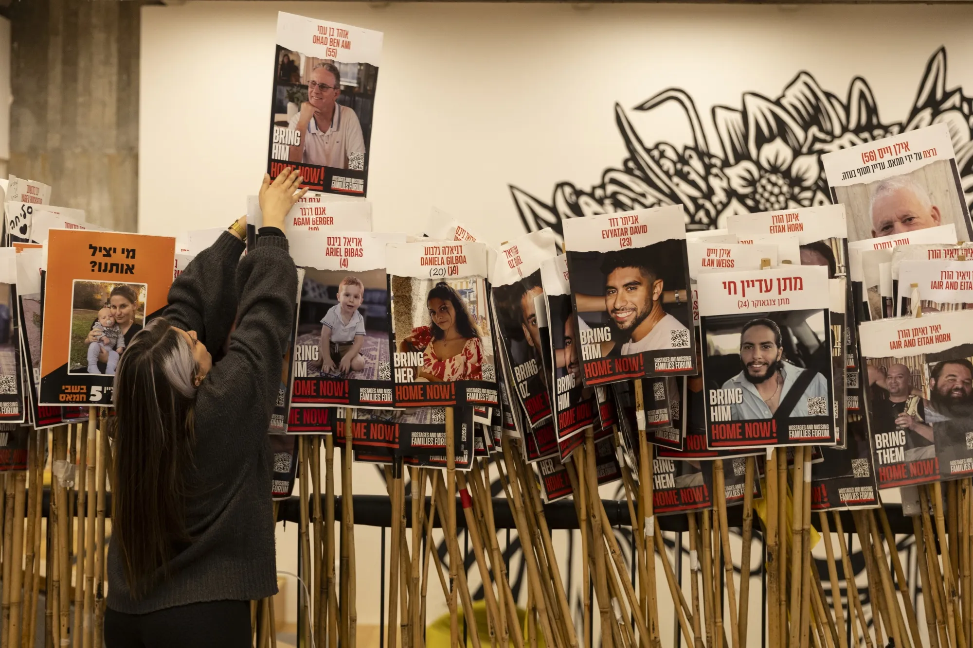 An activist sets up photos of hostages held in the Gaza Strip in Tel Aviv, Israel, on Dec. 17.&nbsp;