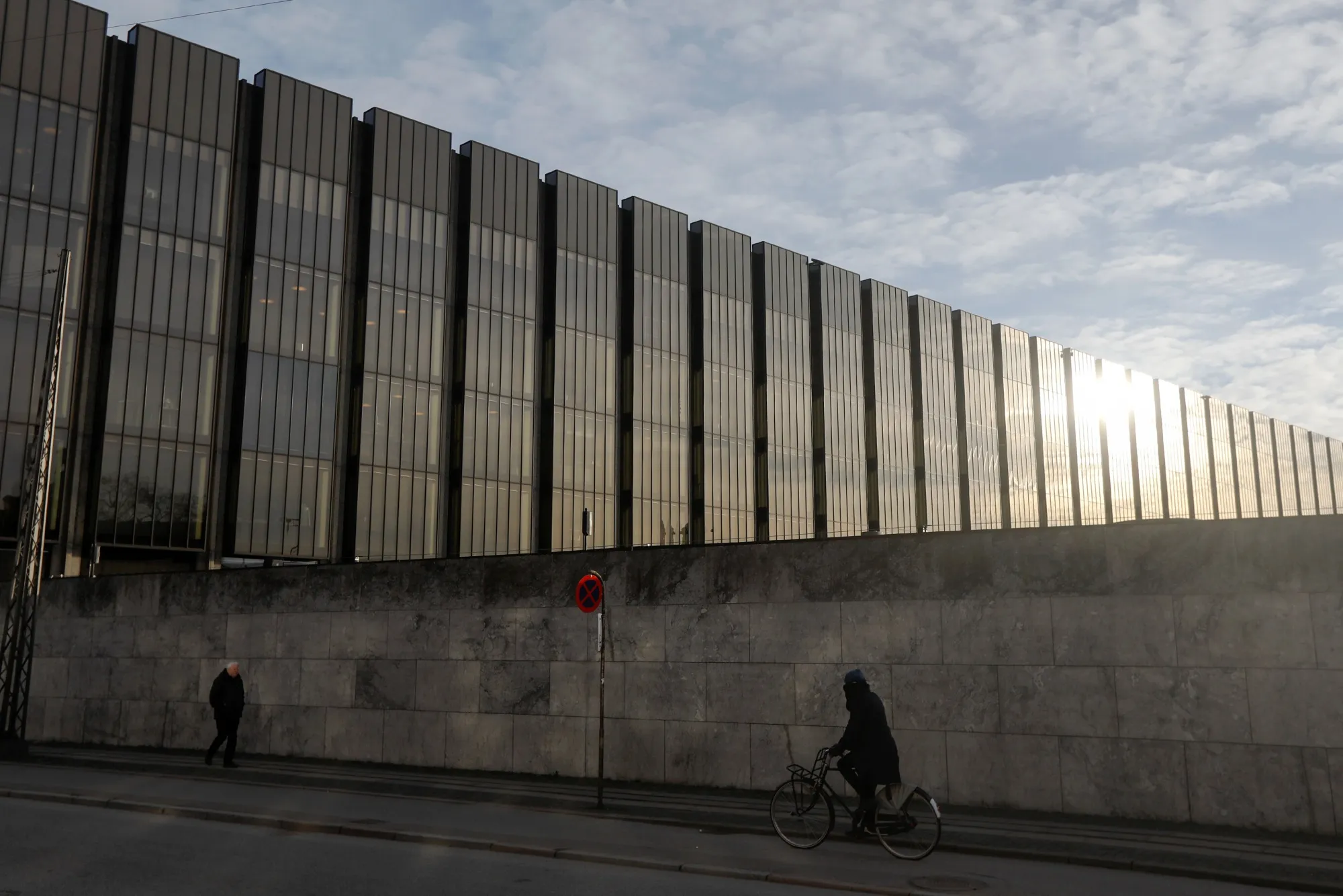 A cyclist passes Denmark's central bank in Copenhagen, Denmark.