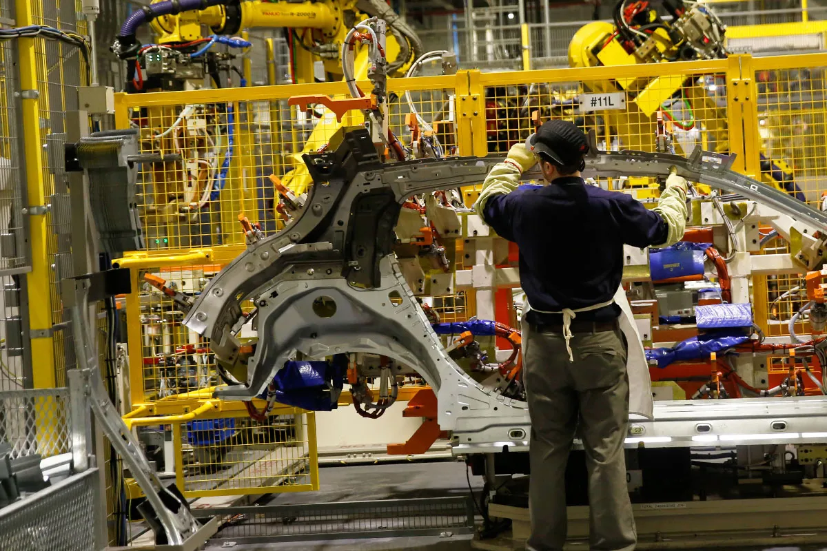 An employee handles a side panel of an Infiniti Q30 automobile on the production line at the Nissan Motor Co. production plant in Sunderland, U.K., on Thursday, Dec. 3, 2015. Nissan rose 0.7 percent at the close Thursday in Tokyo trading.
