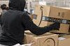 An employee moves an Amazon.com Inc. package for delivery at the United States Postal Service (USPS) Joseph Curseen Jr. and Thomas Morris Jr. processing and distribution center in Washington, D.C., U.S., on Tuesday, Dec. 12, 2017. The USPS said it expects to deliver over 15 billion total pieces of mail this holiday season with expanded Sunday delivery operations in certain areas, delivering over six million packages each Sunday in December.