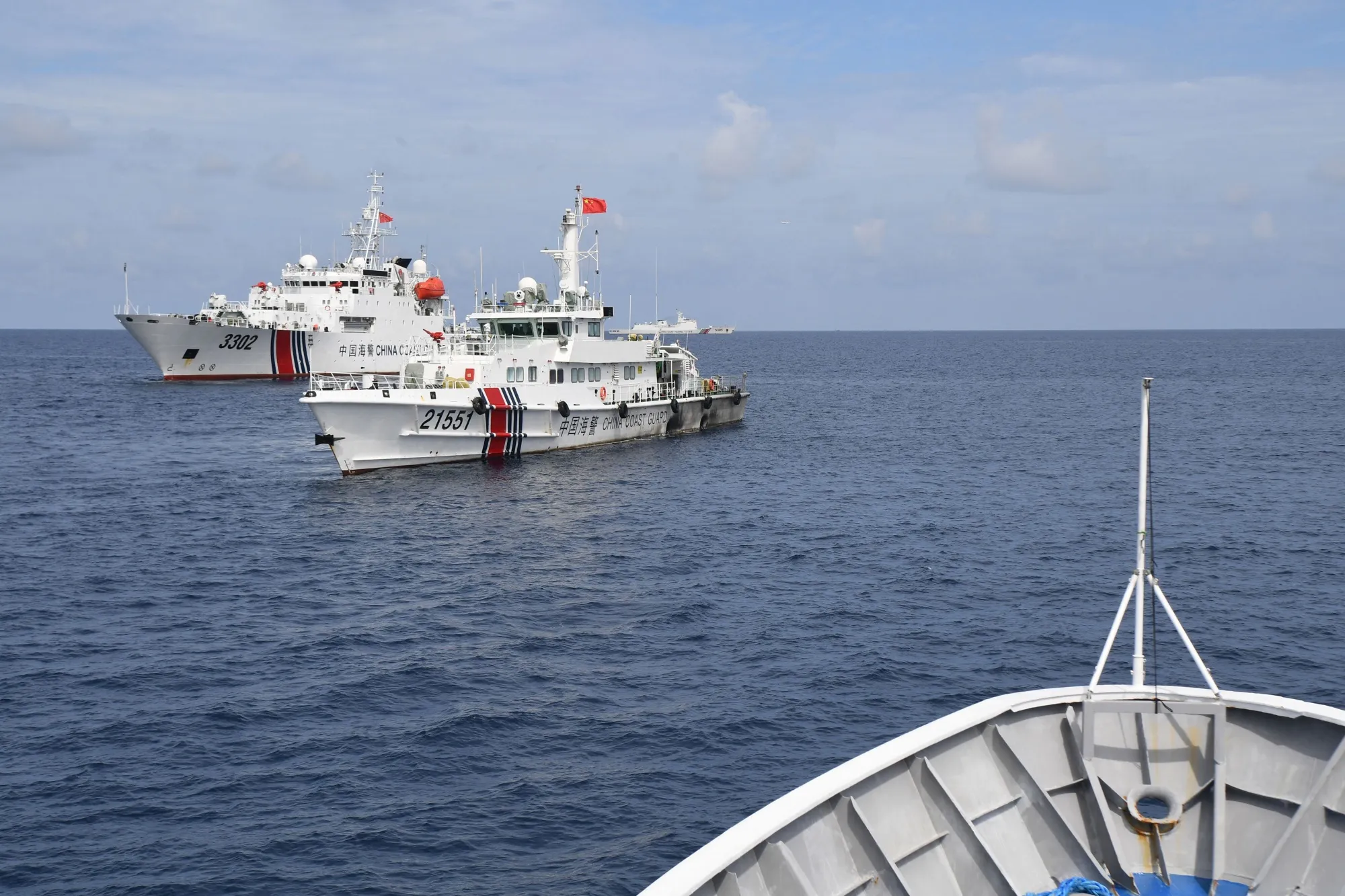 Chinese coast guard ships blocking the path of Philippine coast guard ship BRP Cabra, while escorting a civilian boat, not pictured, chartered by the Philippine navy to deliver supplies to Philippine navy ship BRP Sierra Madre in the disputed South China Sea, on Aug. 23.
