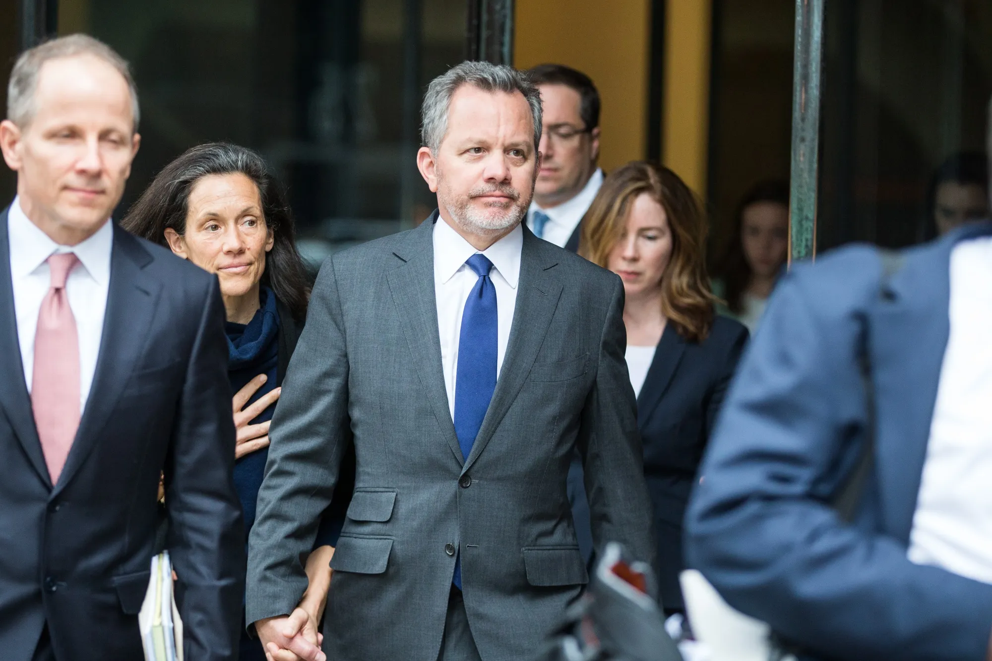 Bill McGlashan, center, exits federal court in Boston, Massachusetts, on&nbsp;March 29, 2019.&nbsp;