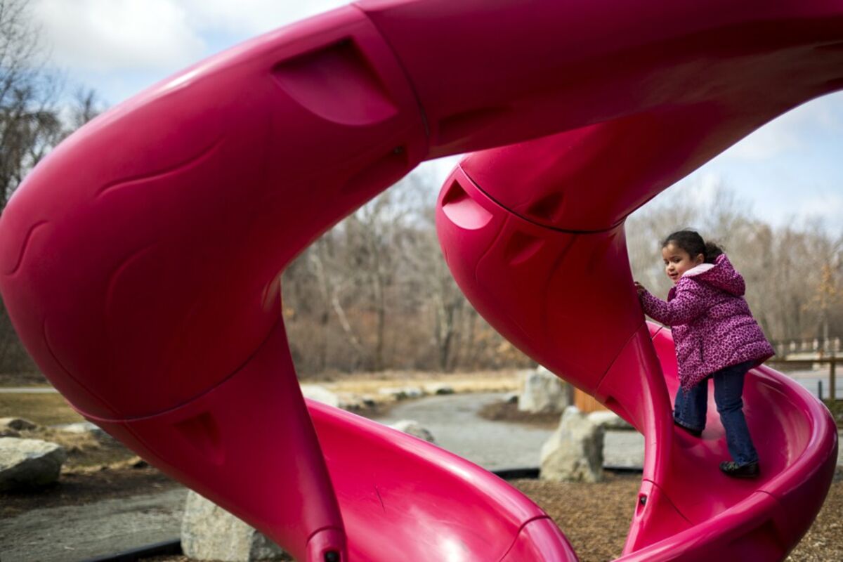 Children Playing On Playground In City Park Engaged In Football