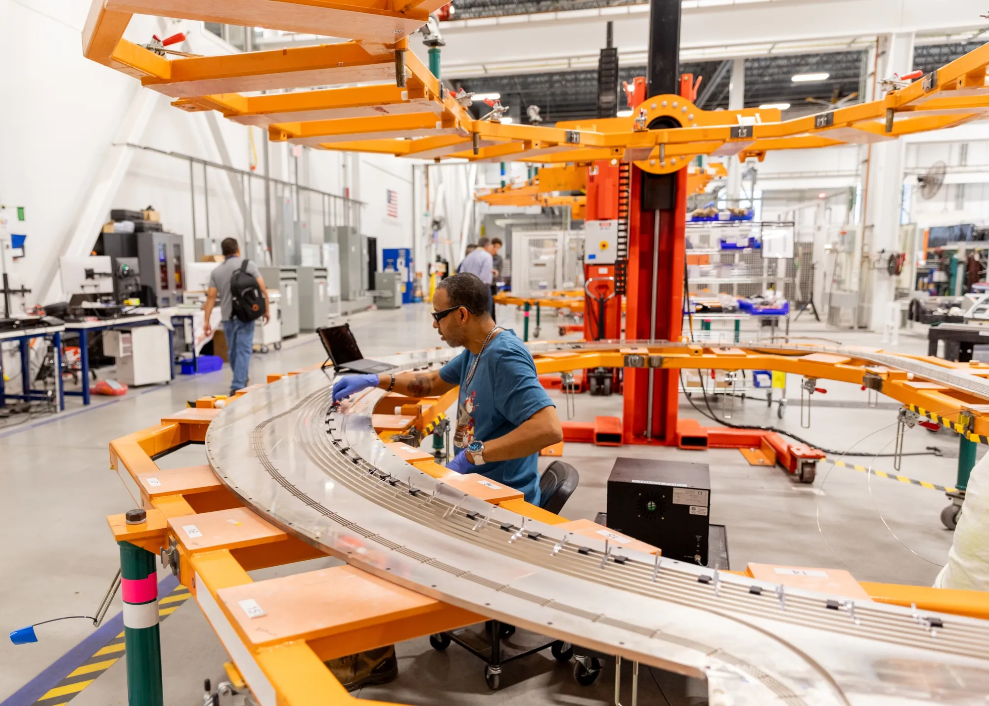 A worker assembles toroidal field magnets at the Commonwealth Fusion Systems campus in Devens, Massachusetts.