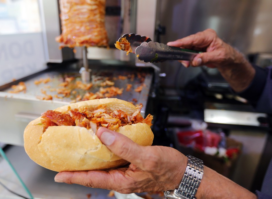 A man prepares a kebab in a fast-food restaurant in Marseille