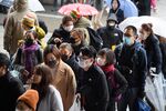 Tourists wearing face masks walk along a shopping street leading to the Sensoji temple in the Asakusa district of Tokyo, Japan, on Tuesday, Jan. 28.