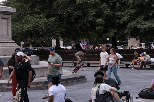 A skateboarder performs a trick on the base of the Columbus Circle statue in New York. 