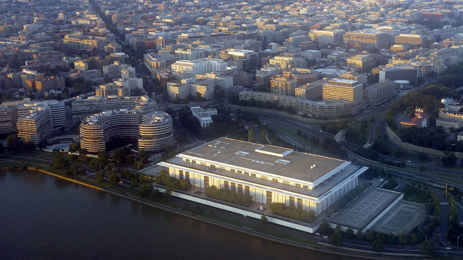 The John F. Kennedy Center for the Performing Arts and the Watergate Complex on the banks of the Potomac River is seen from the air at sunset in this photograph taken on June 15, 2014 over Washington, DC.
