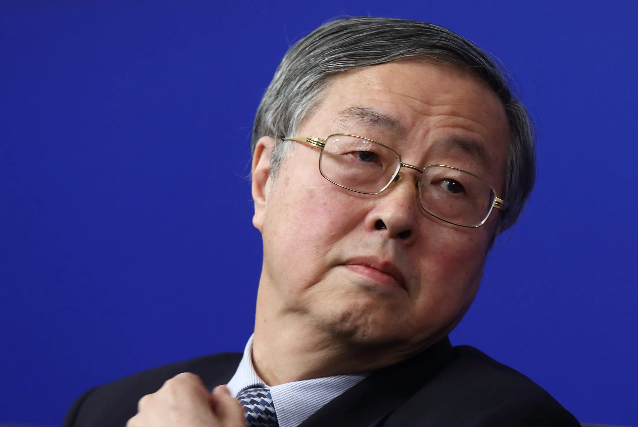 Zhou Xiaochuan, governor of the People's Bank of China (PBOC), attends a news conference in Beijing, China, on Thursday, March 12, 2015. China's central bank is pushing ahead with plans to liberalize interest rates even as the economy slows, a reform that would effectively end a dual-track rate system that has seen savers subsidize decades of investment-fueled growth.
