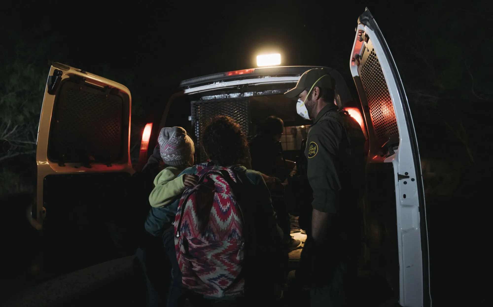 Migrants are processed by U.S. Border Patrol agents after illegally crossing the border over the Rio Grande River in Roma, Texas.