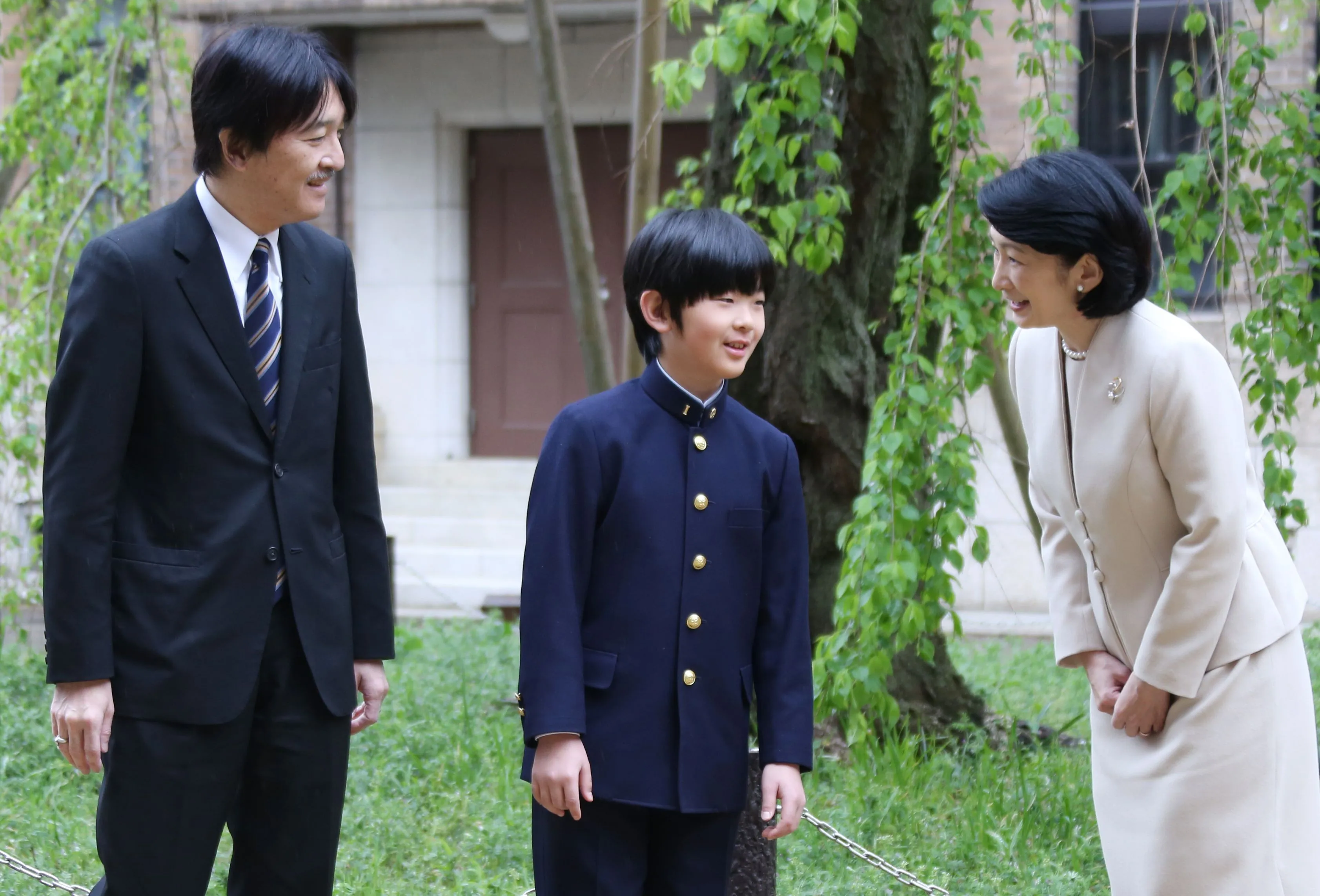 Japan's Prince Hisahito, center, accompanied by his parents Prince Akishino, left,&nbsp;and Princess Kiko,&nbsp;at Ochanomizu University junior high school before attending the entrance ceremony in Tokyo on April 8.
