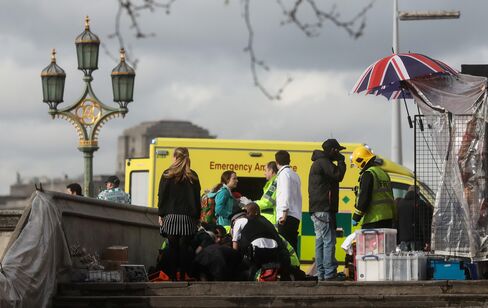 Emergency services tend to an injured individual on Westminster Bridge on March 22.