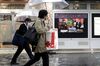 Pedestrians walk past a screen, displaying a news broadcast of the U.S. President Donald Trump and North Korean Leader Kim Jong Un during the the DPRK-USA Hanoi Summit, in Tokyo, Japan, on Thursday, Feb. 28, 2019. Trump and Kim sounded an optimistic note at the start of their second set of face-to-face meetings, as the U.S. leader sought to advance nuclear talks that have largely stalled since their first summit in June.