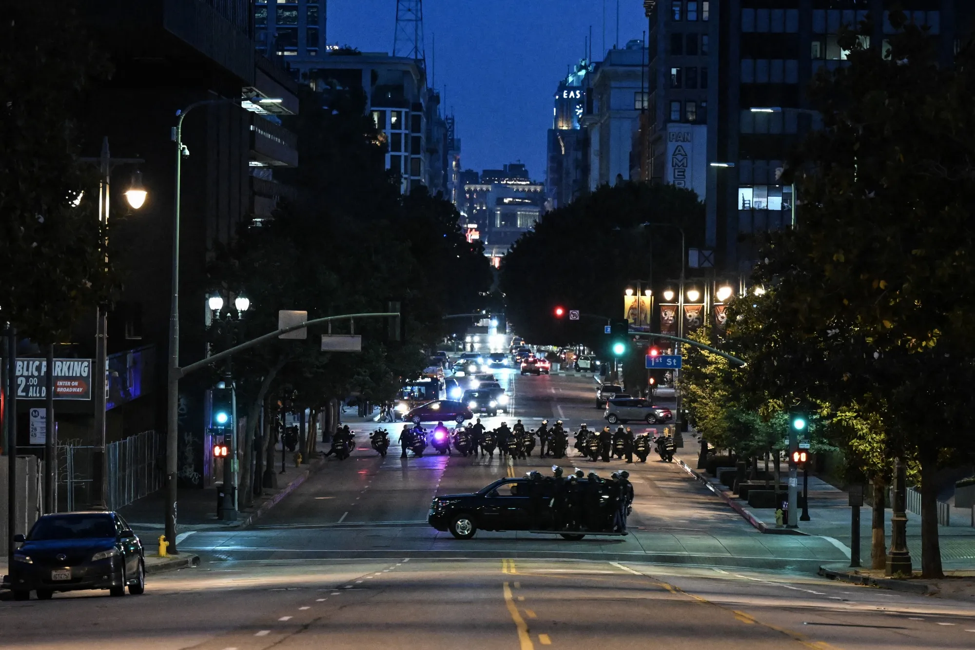Police are seen in an empty street of Los Angeles after a second night of curfew on June 11.