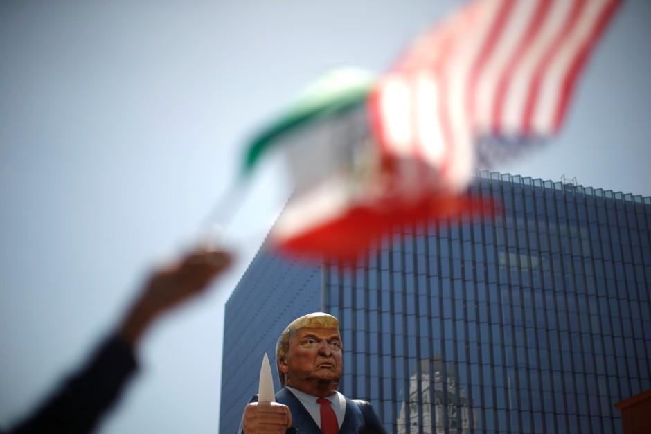 Protesters wave flags in front of an effigy of Donald Trump in Los Angeles.