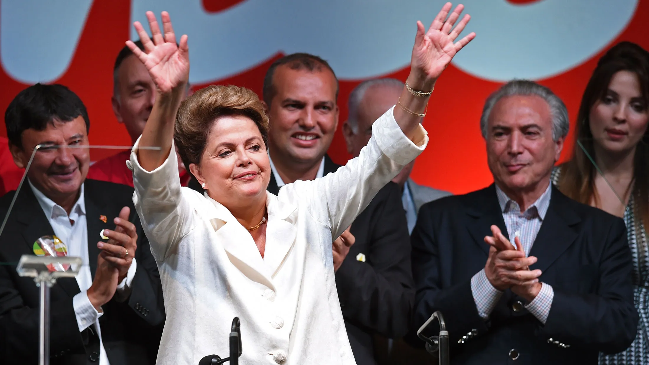 Re-elected Brazilian President Dilma Rousseff waves next to her vice president, Michel Temer (right), following her win in Brasilia on Oct. 26, 2014.
