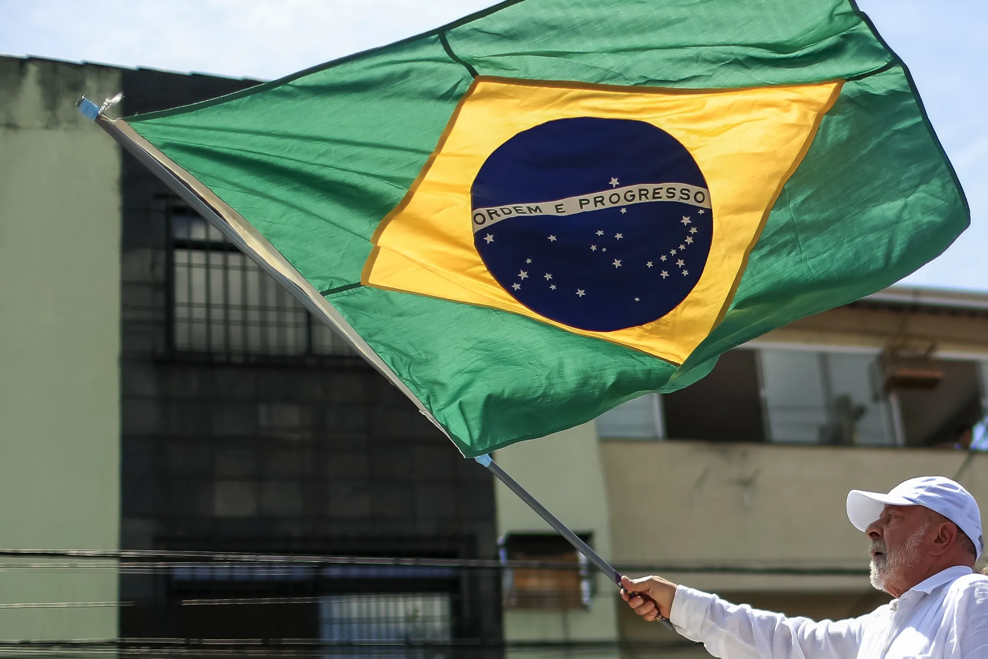 Luiz Inacio Lula da Silva waves a Brazilian flag&nbsp;in Sao Gonçalo, Brazil.&nbsp;