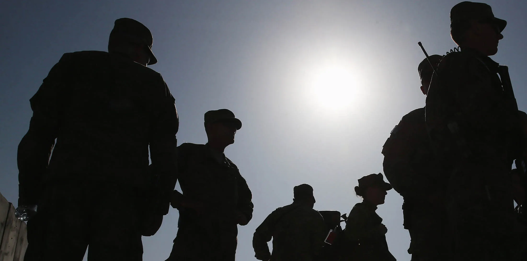 FOB GAMBERI, AFGHANISTAN - DECEMBER 07: Members of the US military stand by after listening to U.S. Secretary of Defense Chuck Hagel speak to American troops, December 7, 2014 in FOB Gamberi, Afghanistan. Secretary Hagel visited the Forward Operating Base to meet with Afghanistan military officials and visit with American troops stationed there.

