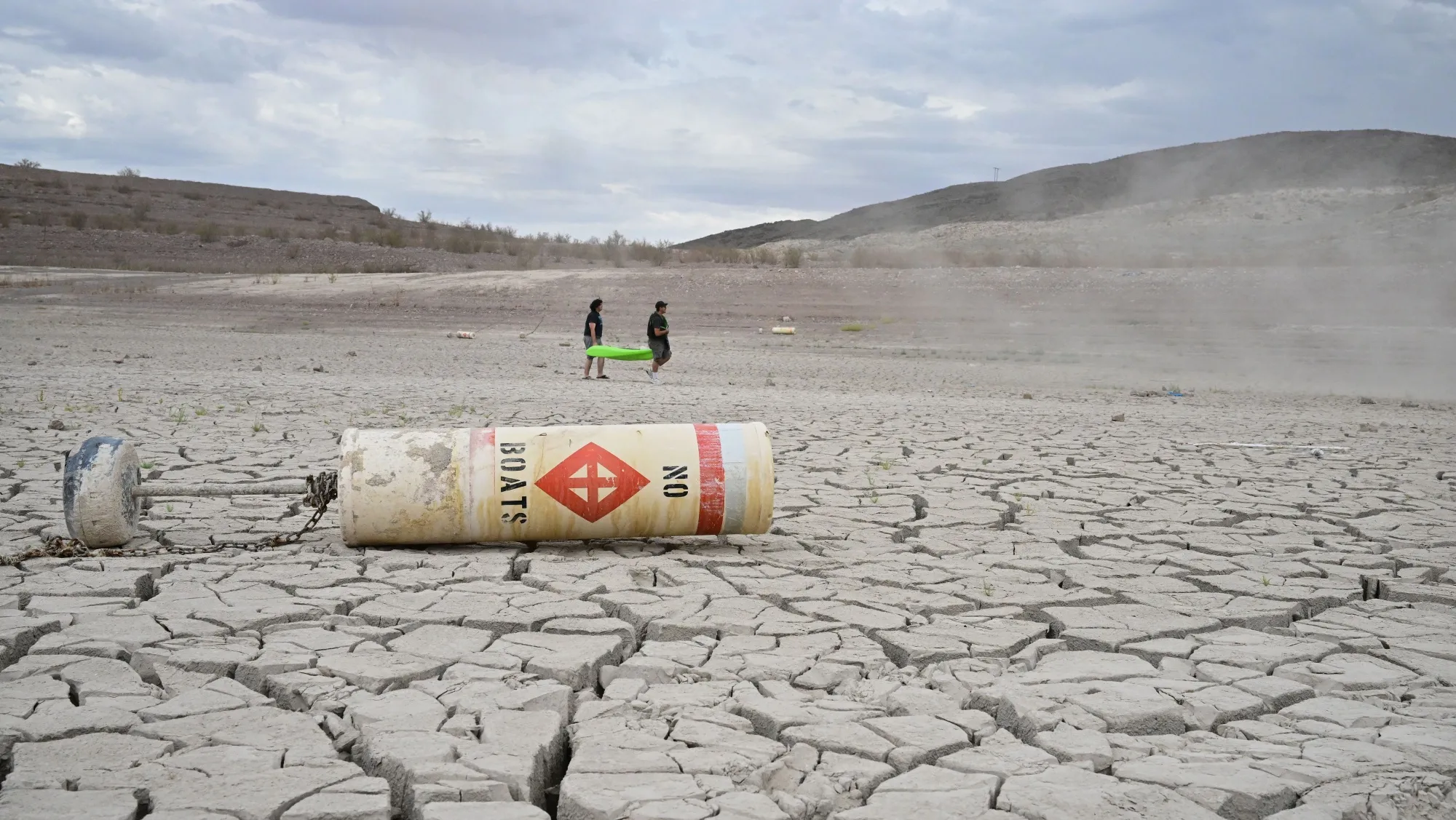 A buoy that reads 'No Boats' lays on the ground&nbsp;as people carry a boat at Lake Mead, Nevada on July 23.