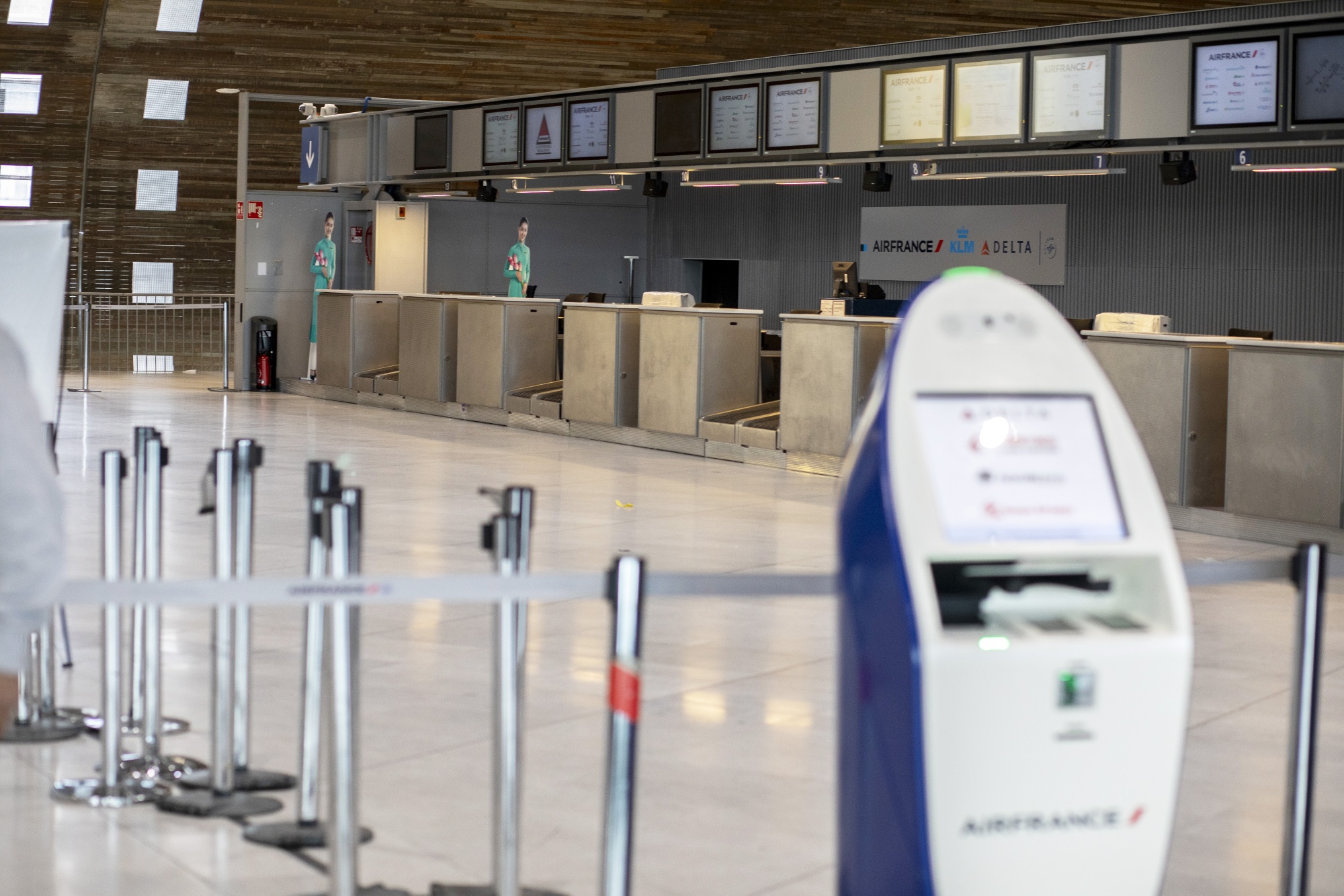 Service desks stand empty at the Air France-KLM check-in area at Charles de Gaulle Airport,&nbsp;in Roissy, France, on&nbsp;March 16.