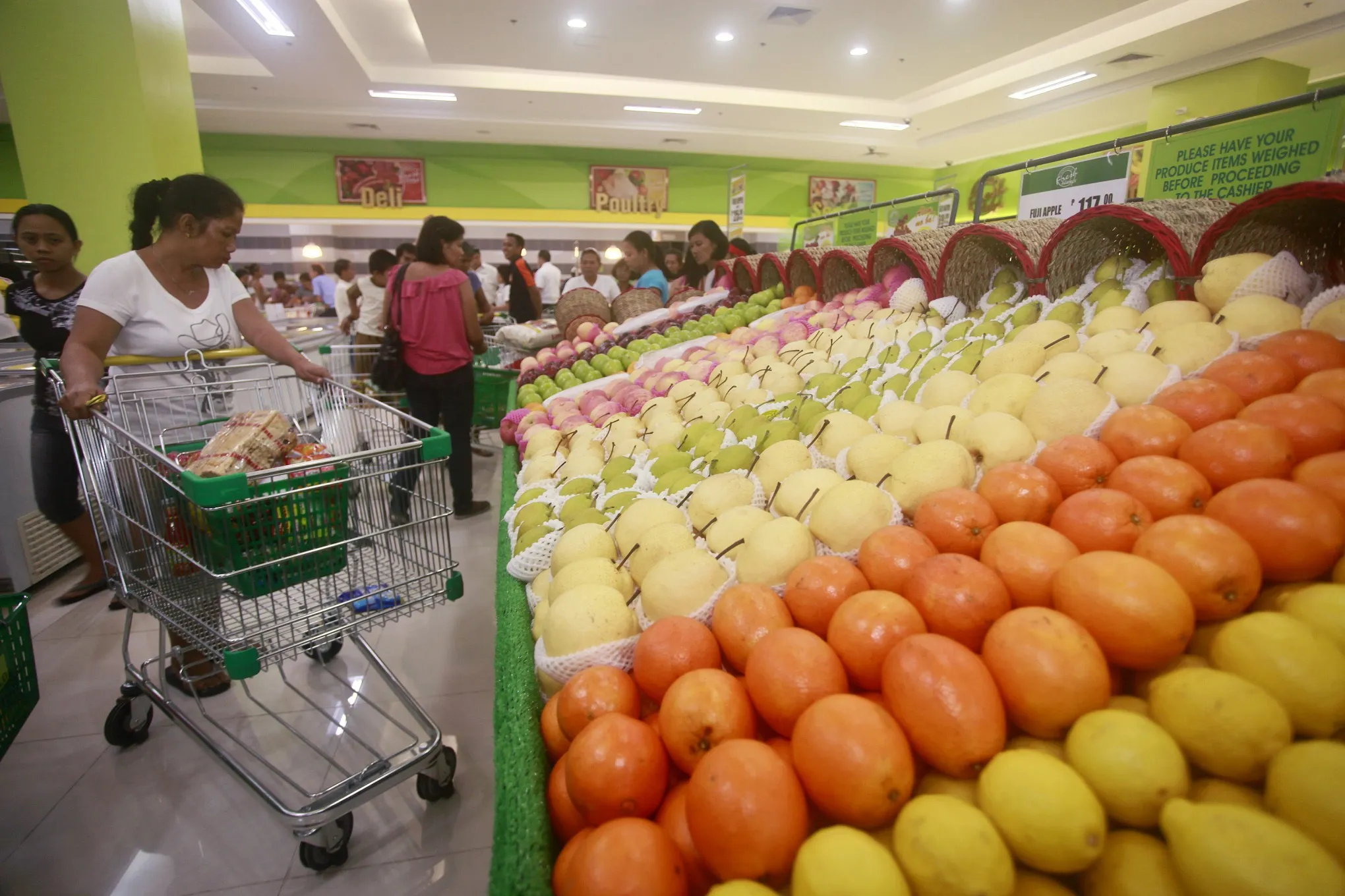 Shoppers browse produce at a Puregold Price Club store in Manila.