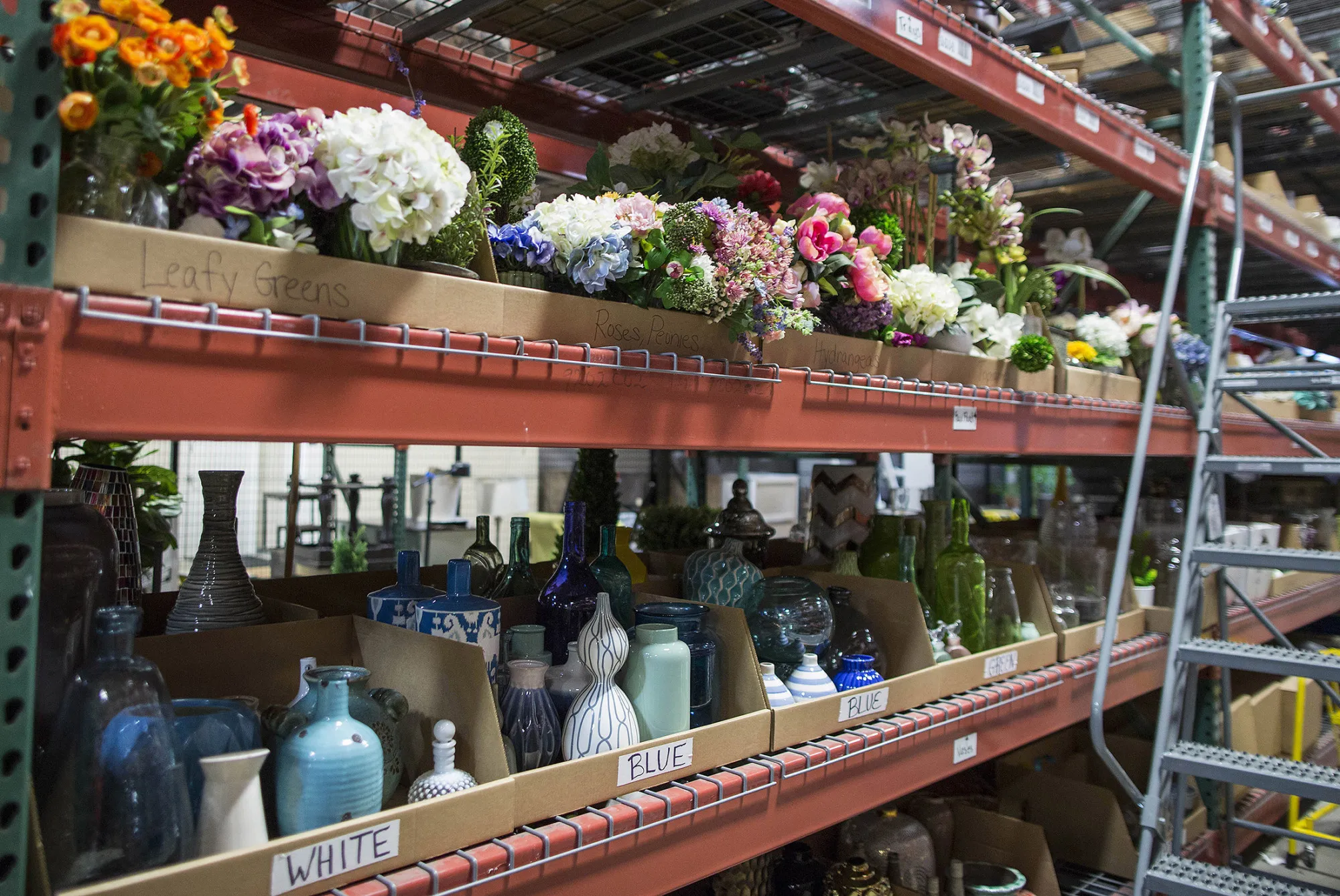 Vases and fake flower props sit on shelves in a storage area at the Wayfair Inc. photo studio in Westborough, Massachusetts, U.S., on Tuesday, May 24, 2016. Wayfair is the largest online-only retailer for home furniture in the U.S.
