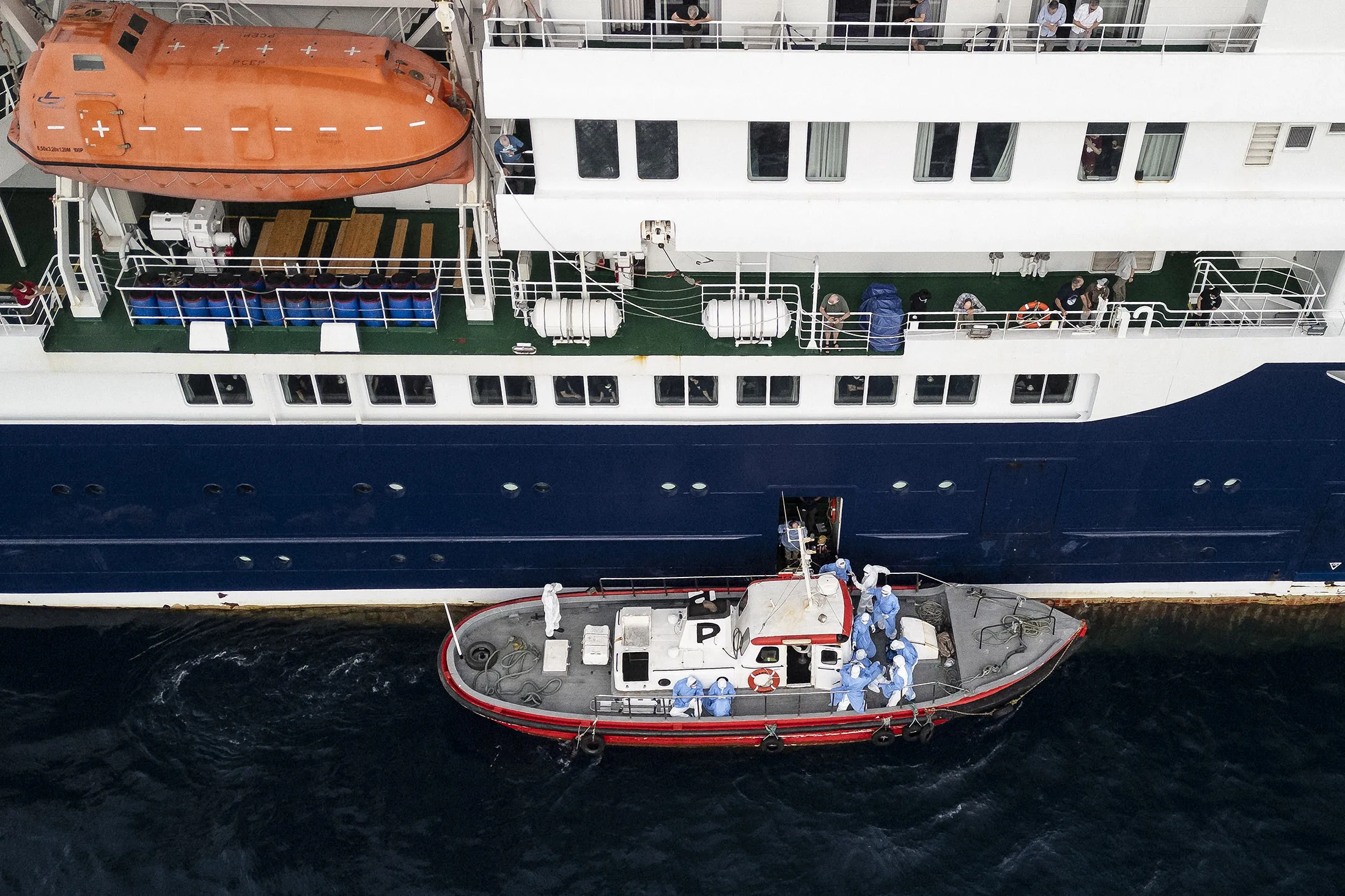 Health personnel assisting patients onto a boat from the cruise ship MV Hondius, while stationary off the port of Praia, the capital of Cape Verde, on May 6.