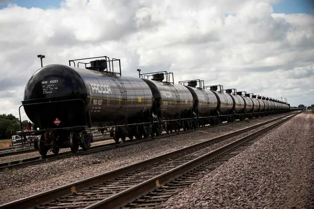 Oil containers sit at a train depot on July 26, 2013, outside Williston, N.D.