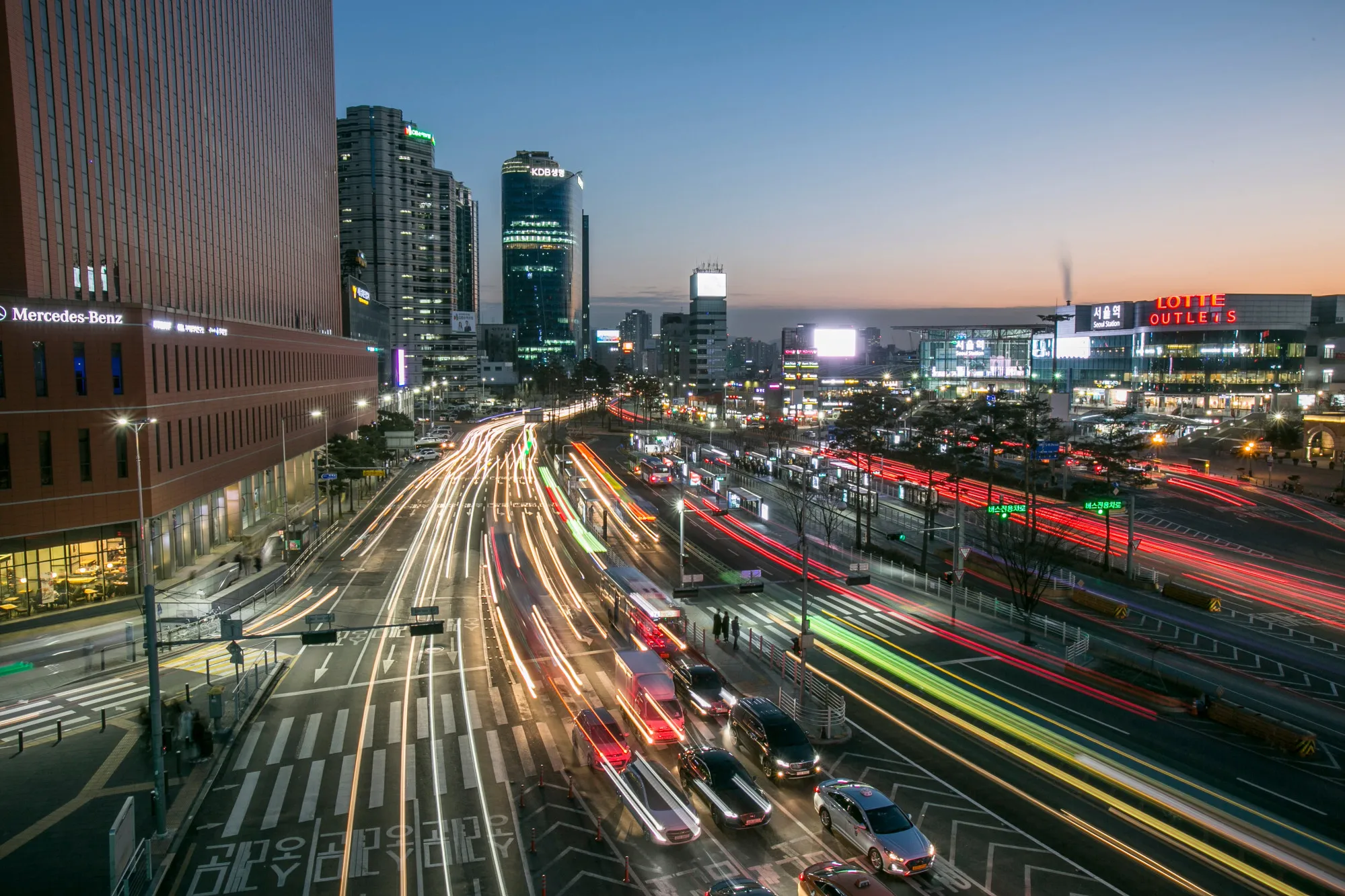 Light trails from passing traffic illuminate a road at dusk in Seoul, South Korea, on Saturday, Jan. 27, 2018.