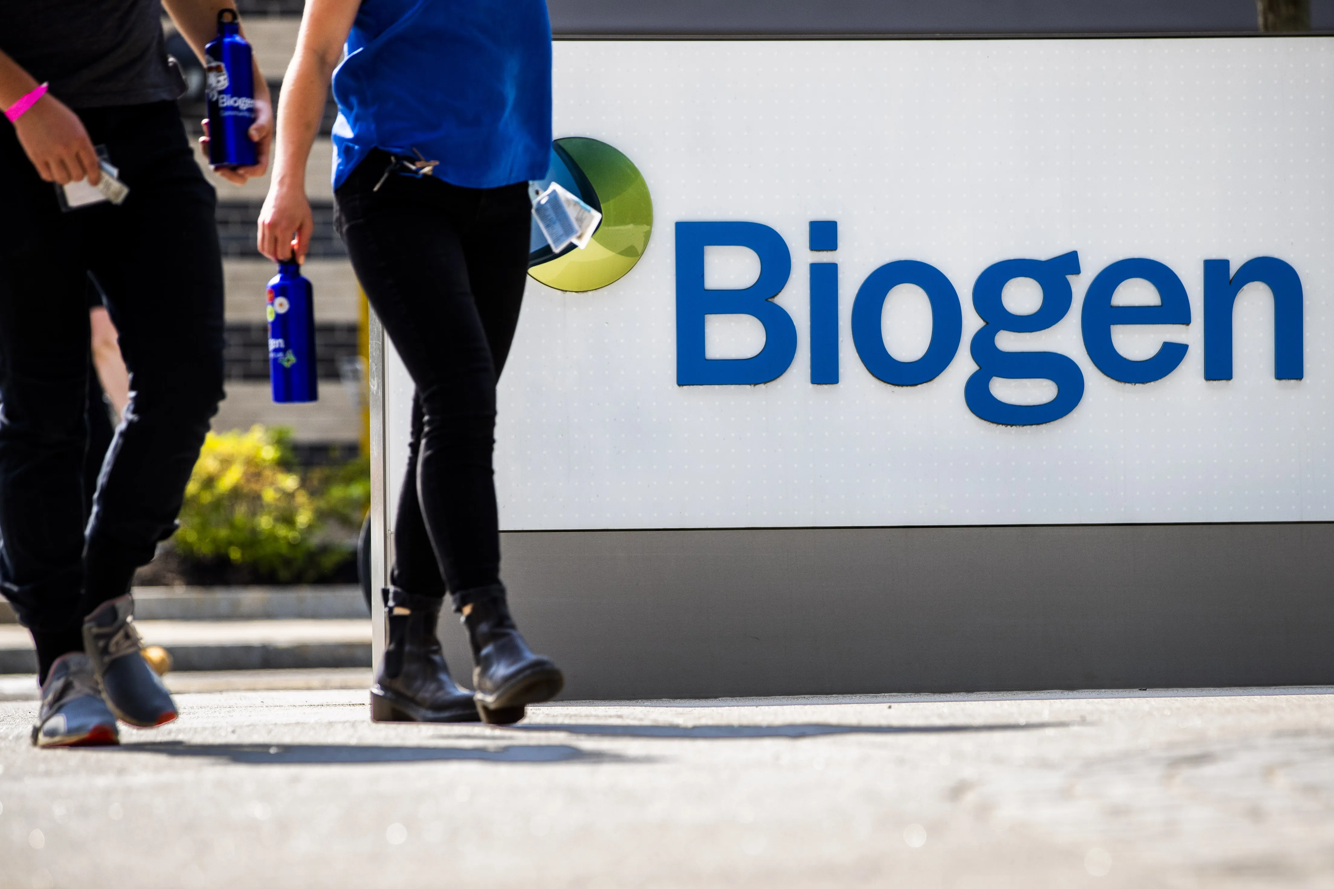 Pedestrians walk past Biogen Inc. headquarters in Cambridge, Massachusetts.