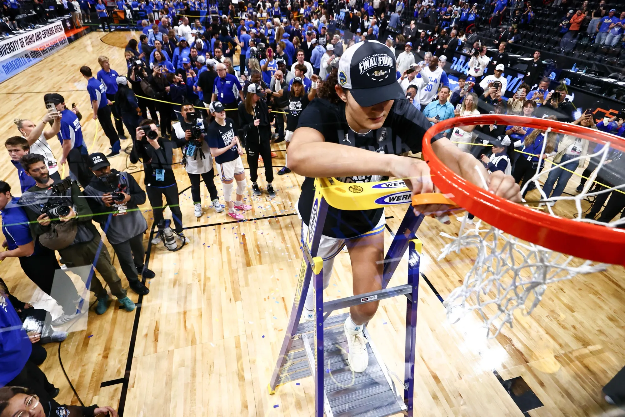 Lauren Betts, of&nbsp;UCLA,&nbsp;cuts a piece of the net following the team's win over LSU in the Elite Eight round of the 2025 NCAA Women's Basketball Tournament.
