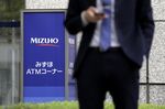Signage for automated teller machines (ATM) at a Mizuho Bank Ltd., a unit of Mizuho Financial Group Inc. (MHFG), is displayed outside a branch in Tokyo, Japan, on Friday, May 10, 2019.