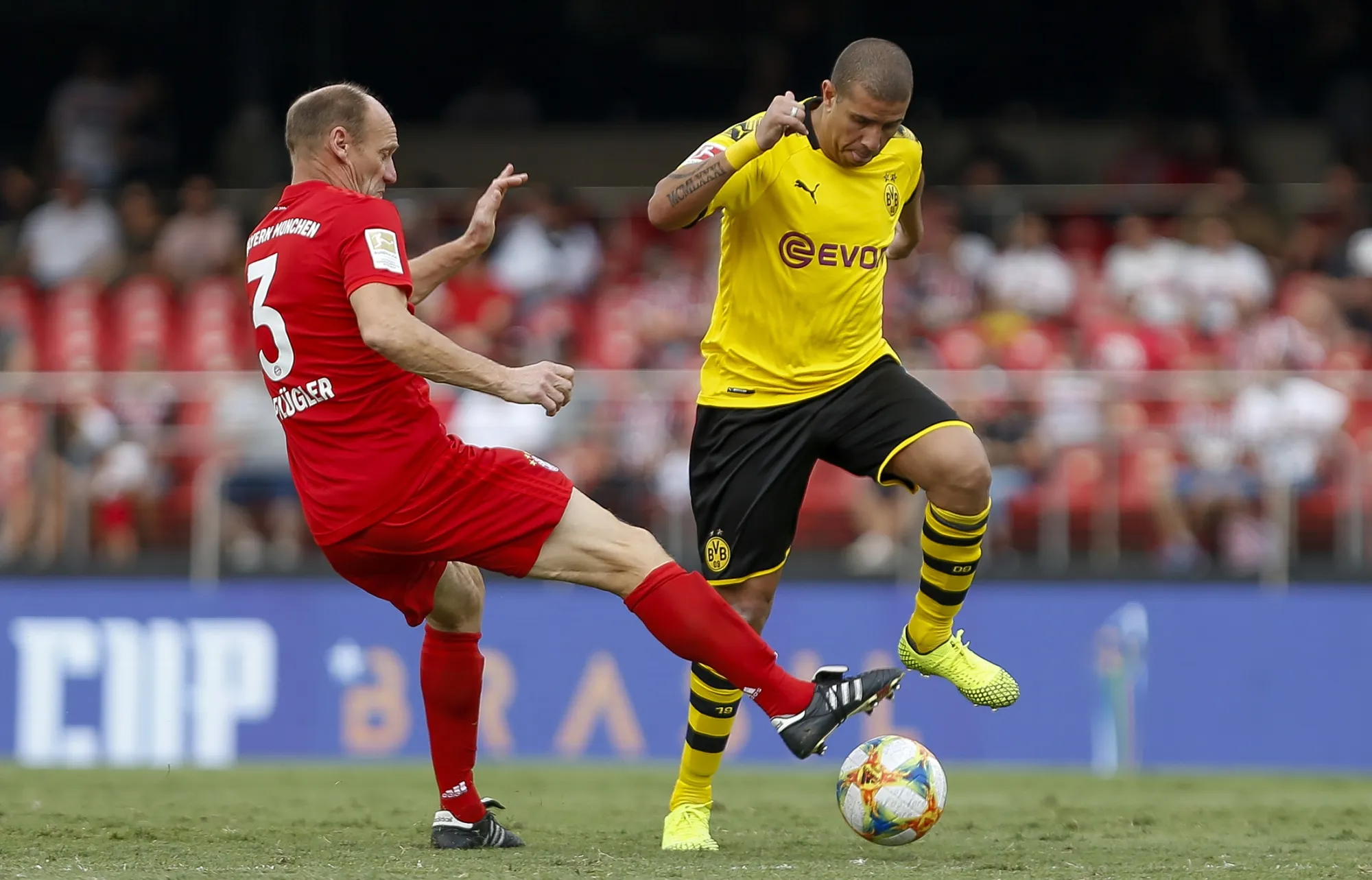 Players from FC Bayern Muenchen and Borussia Dortmund during a match.