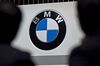 Attendees stand near Bayerische Motoren Werke AG (BMW) signage.