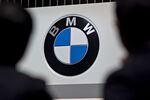 Attendees stand near Bayerische Motoren Werke AG (BMW) signage.