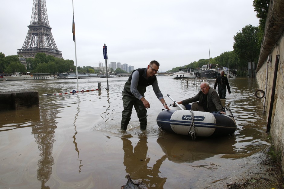Houseboat residents take to dinghies to reach their homes in Paris.