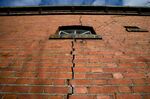 A crack is seen in the wall of a farm after a series of small tremors caused by decades of gas extraction, in Hunzinge, in Groningen province, northern Netherlands, Friday, Jan. 19, 2018. The Dutch government has sparked anger in the northern province that has been hit by a string of small earthquakes in recent years by announcing it may have to double the amount of gas it pumps from there region this year. (AP Photo/Peter Dejong, File)