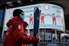 A ski instructor walks past social distancing signs in Verbier.