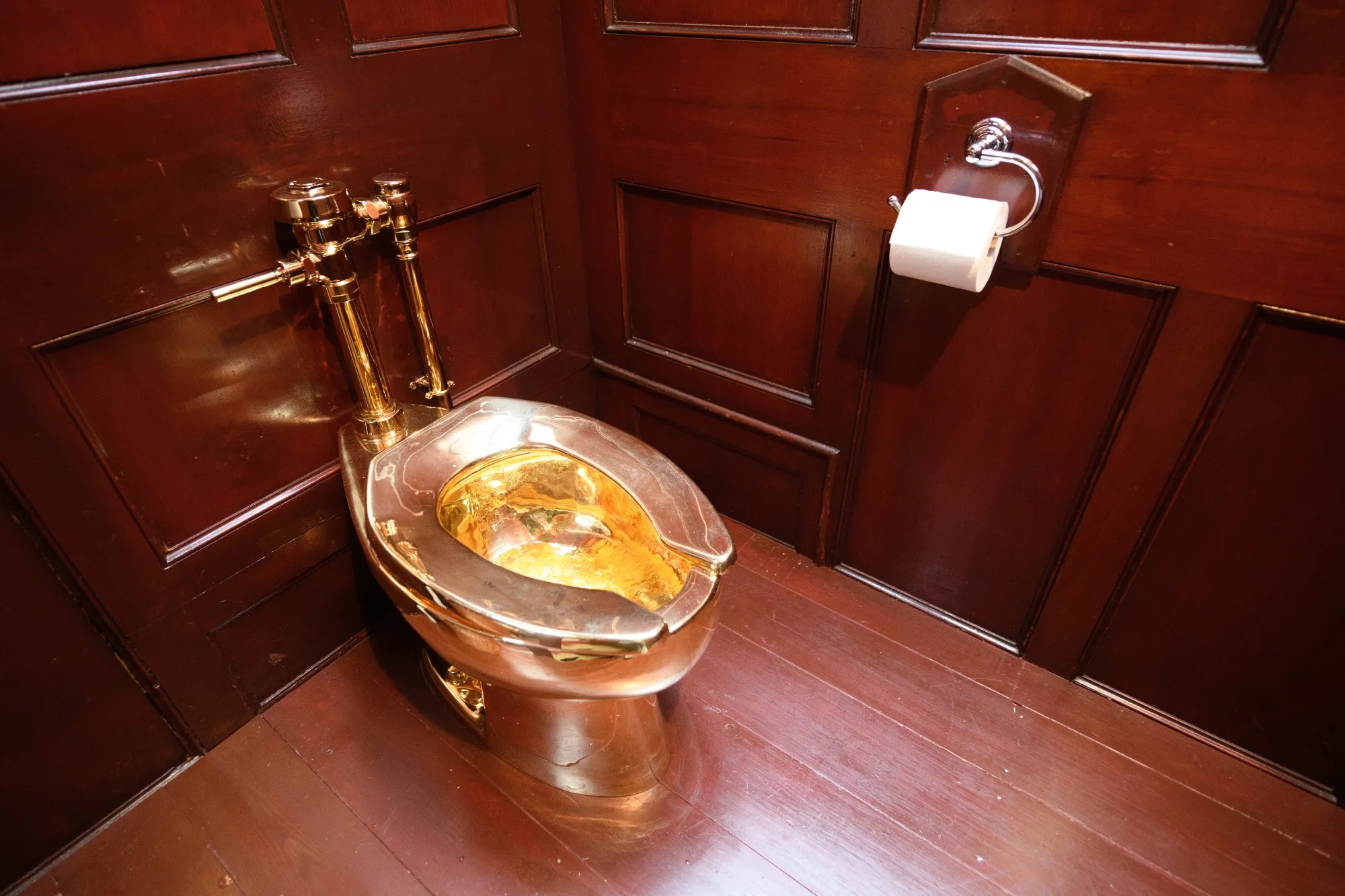 A solid gold toilet, created by artist Maurizio Cattelan, is seen at Blenheim Palace in Woodstock, England.&nbsp;