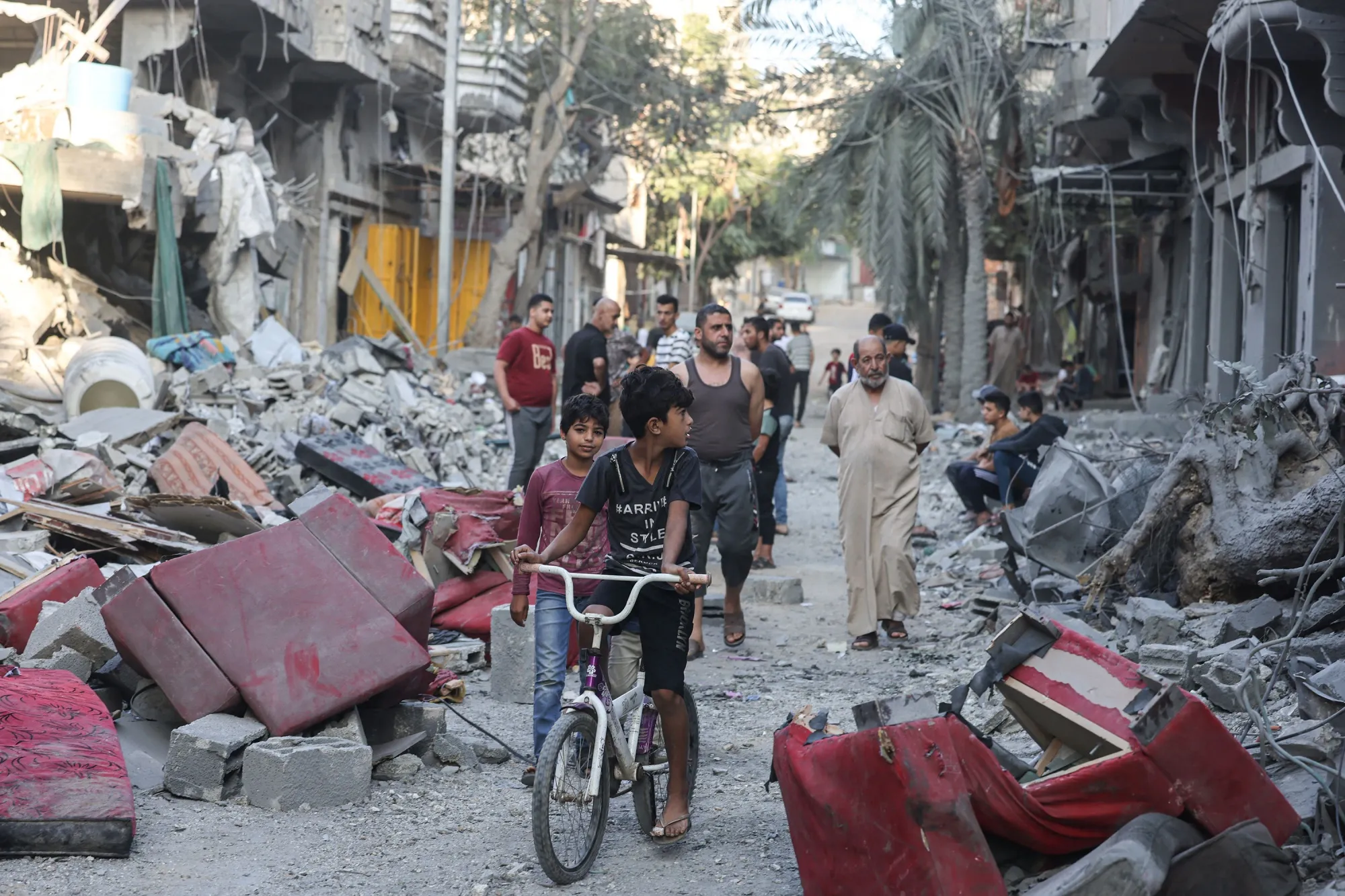 Residents among destroyed buildings at the Nuseirat refugee camp, in the Gaza Strip on Oct.&nbsp;30.
