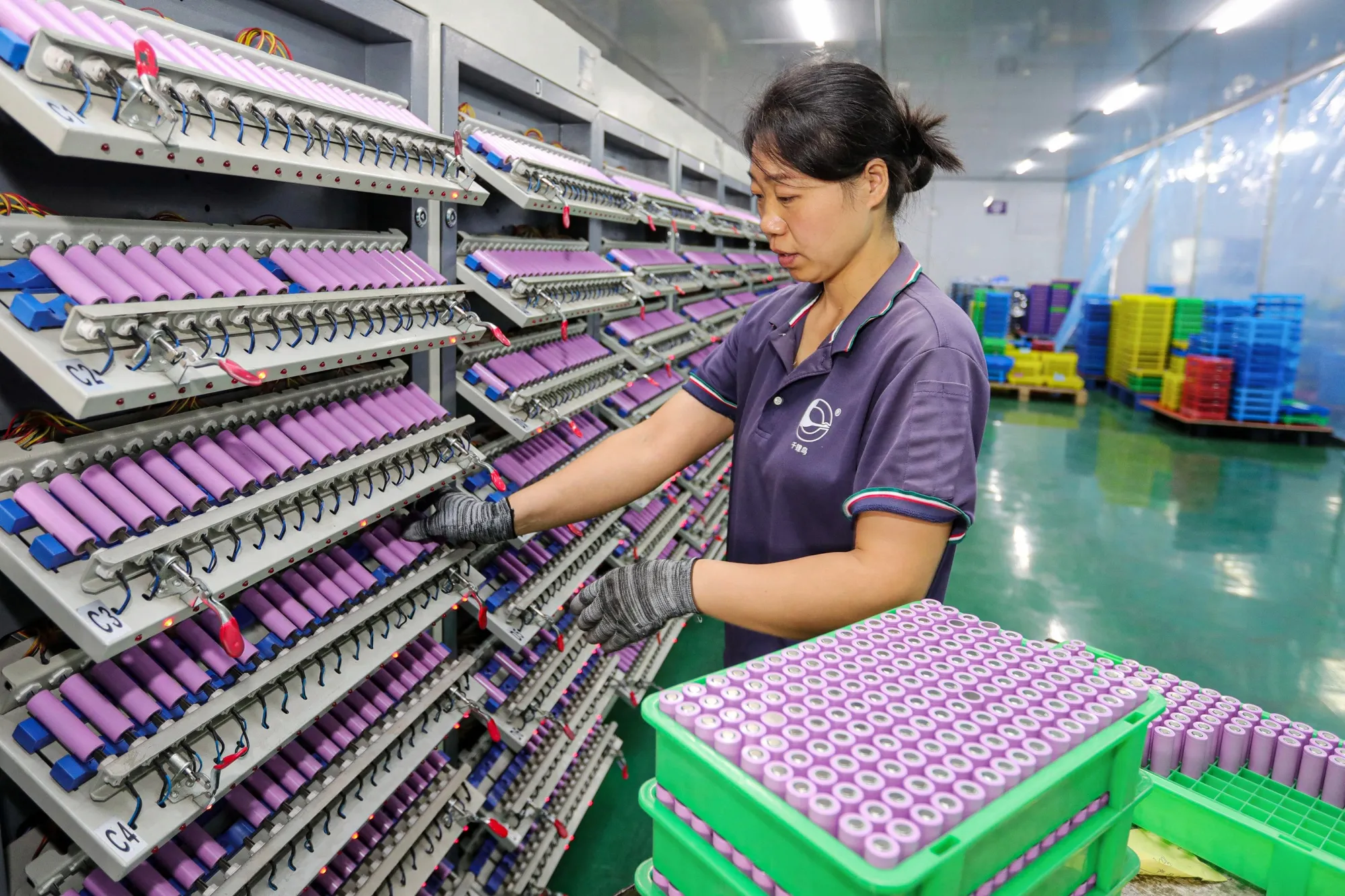 An employee works at a company manufacturing lithium batteries in Anhui province.