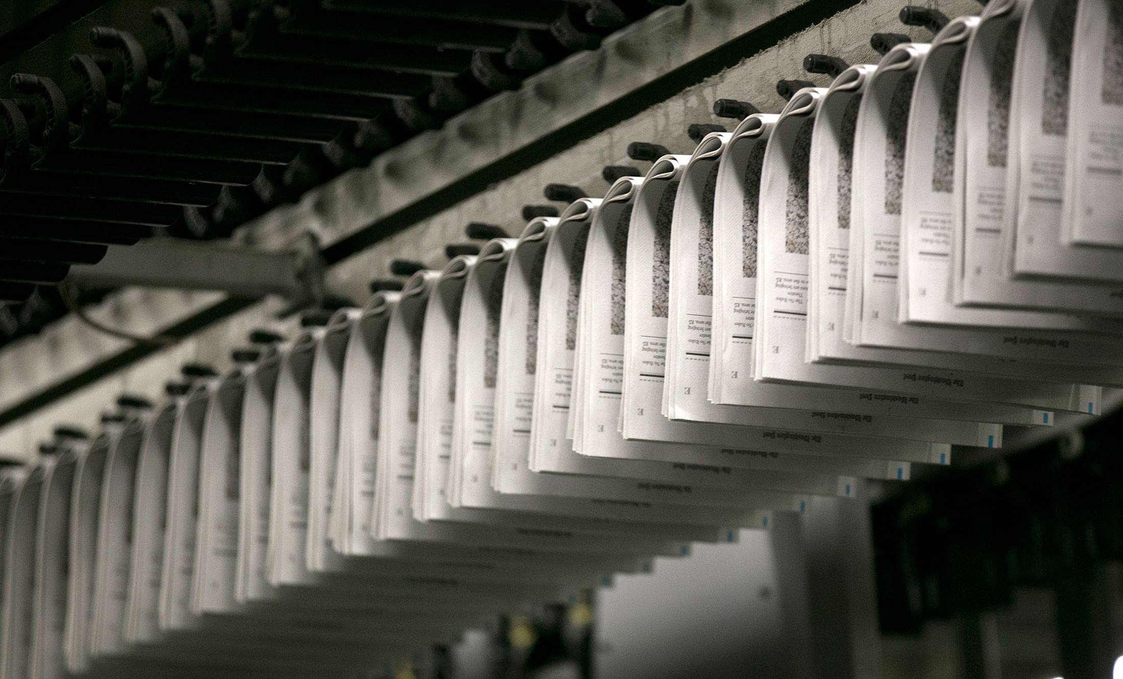 Sections of the Washington Post travel on a conveyor at the newspaper production facility in Springfield, Virginia, U.S., on Friday, July 12, 2013.
